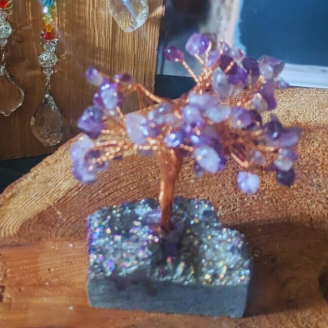 Beautiful amethyst crystal shining in sunlight coming through a window.