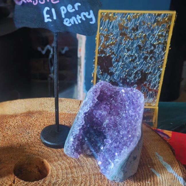 Beautiful amethyst crystal shining in sunlight coming through a window.